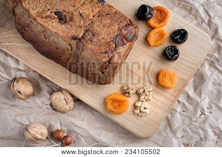 Rye Bread With Nuts, Dried Fruits, Apricots And Prunes, Dessert. The Whole Loaf And The Cut Pieces O