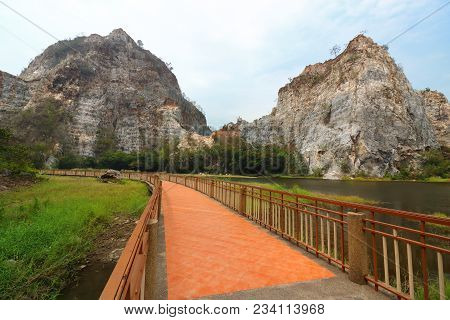 Beautiful Walkway With Rocky Mountain Background Of Khao Ngu Stone Park , Ratchaburi , Thailand.