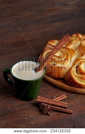 Homemade Rose Bread With Raisins On Wooden Tray, Cup Of Creamy Coffee, Anise And Cinnamon Over Vinta