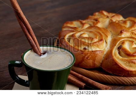 Homemade Rose Bread With Raisins On Wooden Tray, Cup Of Creamy Coffee, Anise And Cinnamon Over Vinta