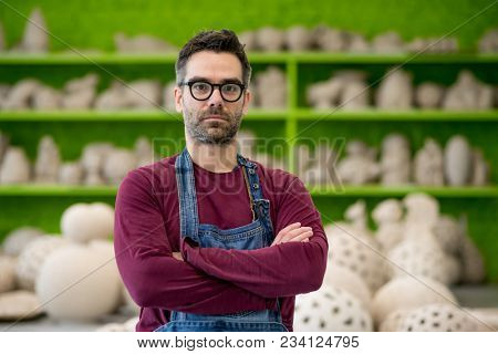 Portrait of Young Ceramist in the Bright Modern Ceramic Workshop. Small Business Concept.