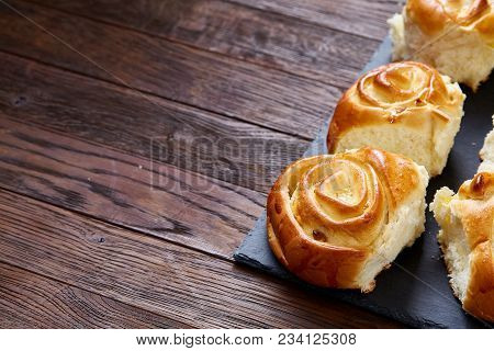 Homemade Rose Buns With Raisins On Wooden Cutting Board Over Rustic Vintage Background, Close-up, Sh