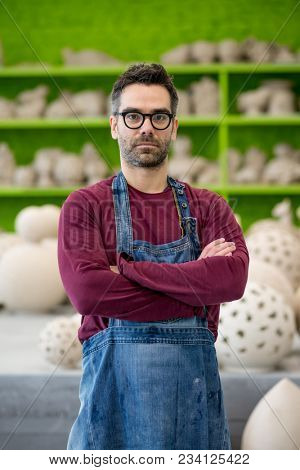 Portrait of Young Ceramist in the Bright Modern Ceramic Workshop. Small Business Concept.