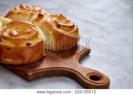 Homemade Rose Buns With Raisins On Wooden Cutting Board Over White Textured Background, Close-up, Sh