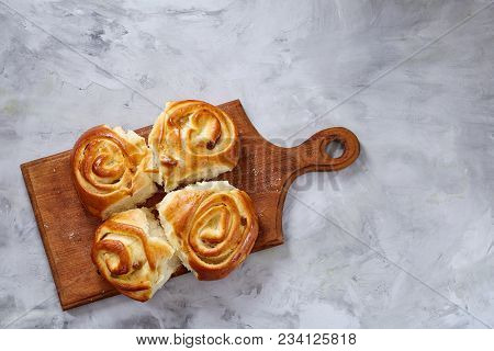 Homemade Rose Buns With Raisins On Wooden Cutting Board Over White Textured Background, Close-up, Sh