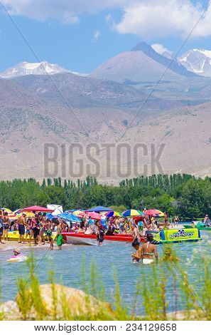 People Enjoy Hot Weather Near Cholpon-ata Beach , Issyk-kul Lake, Kyrgyzstan 30.07.2017
