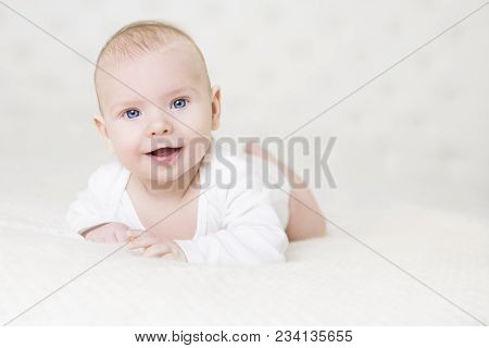 Baby Crawling On White Carpet, Happy Little Kid Portrait, Smiling Infant Child Boy In Bed
