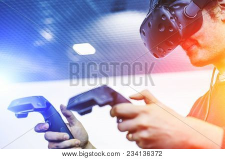 Man Use Virtual Reality Goggles Or Vr Headset Or Helmet, Play Video Game With Wireless Controllers I