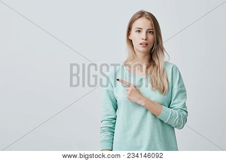 Check This Out Cropped Studio Shot Of Attractive Good-looking Excited Young Woman In Blue Sweater Po