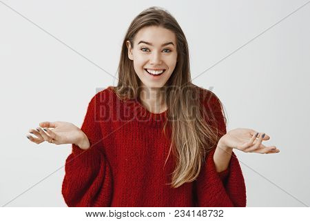 Surprised Emotive Girl Seeing Unbelievable Surprise. Amazed Joyful Woman In Stylish Red Loose Sweate