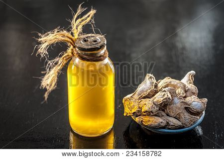 Close Up Of Ayurvedic Herb Or Folk Medicine Dried Ginger Or Zingiber Officinale With Common Cooking