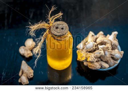 Close Up Of Ayurvedic Herb Or Folk Medicine Dried Ginger Or Zingiber Officinale With Common Cooking