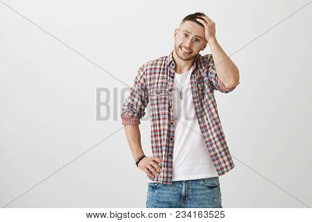 Hot Creative Young Man With Stylish Glasses And Haircut, Smiling Anxiously While Touching Hair, Hold