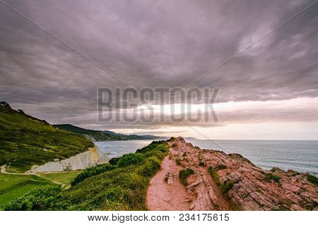 A View To The Coastine Of Basque Country Near Zumaia Fluch With Vibrant Rocks And Dramatic Sunset Sk