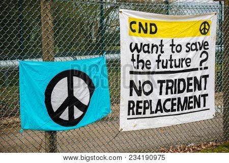 Aldermaston, United Kingdom, 1st April 2018:- Cnd Peace Banners By The Main Gate To The Awe Where Br