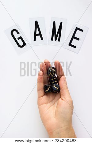 Female Hand Holds Gaming Dice On White Background. Concept With Game Text For Presentation, Banners,