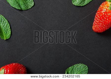 Strawberries And Mint. Red Ripe Berry With Mint Leaves On A Black Background. Copy Space