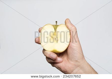 An Apple Fruit Cut In The Hands