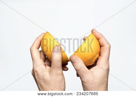 A Pear Fruit Cut In The Hands