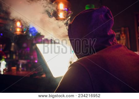 Portrait Of Young Man Smoking An Hookah