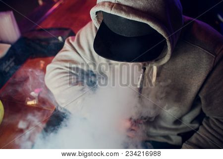 Portrait Of Young Man Smoking An Hookah