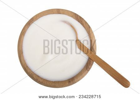 Yogurt In A Wooden Bowl Isolated On White Background Top View.