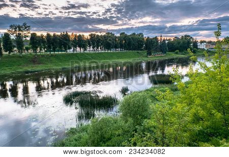 Dramatic sunset sky over the Tvertsa River and its picturesque shores after storm. Russian provincia