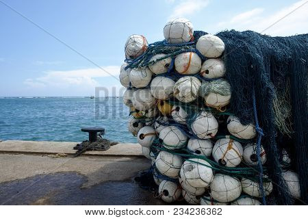 Fsih Net Lying In Harbour. Fishing Tools On Pier
