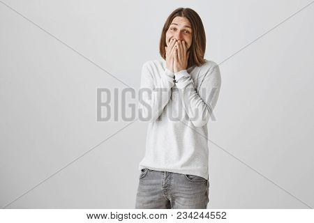 Funny Joyful European Guy Making Fun Of His Friend. Portrait Of Pleased Handsome Male With Long Hair