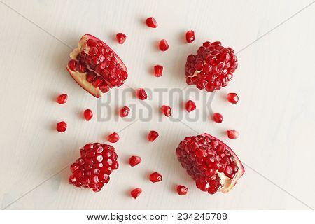 Big Ripe Red Granets Or Garnets. Fruits Of Red Ripe Pomegranate On The White Background. Vegetarian 