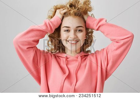 Emotive Positive Young Caucasian Girl With Frizzle Hairstyle, Lifting Hair With Hands And Smiling Br