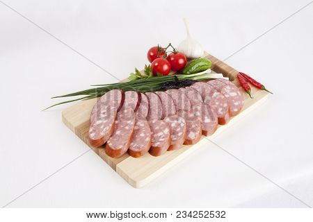 Still Life With Sliced Smoked Sausage Greens And Tomatoes On A White Background. Can Be Used For Ban