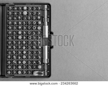 A Set Of Bits For A Screwdriver Of Different Shapes In The Box On A Gray Background Close-up. Tool F