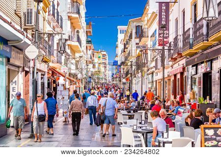 RONDA, SPAIN - OCTOBER 5, 2014: Crowds walk on Calle La Bola pedestrian shopping street in Ronda.