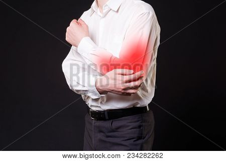Pain In Elbow, Joint Inflammation, Studio Shot With Red Dot On Black Background