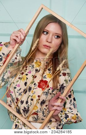 Girl With Long Hair, Long Sleeve Shirt With Floral Print And Wide White Pants. A Wistful Romantic Lo