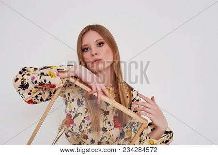 Girl With Long Hair, Long Sleeve Shirt With Floral Print And Wide White Pants. A Wistful Romantic Lo