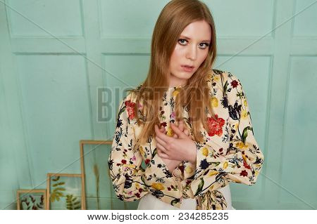 Girl With Long Hair, Long Sleeve Shirt With Floral Print And Wide White Pants. A Wistful Romantic Lo