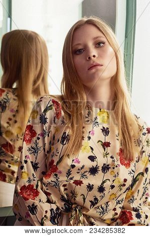 Girl With Long Hair, Long Sleeve Shirt With Floral Print And Wide White Pants. A Wistful Romantic Lo