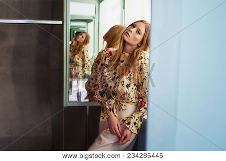 Girl With Long Hair, Long Sleeve Shirt With Floral Print And Wide White Pants. A Wistful Romantic Lo
