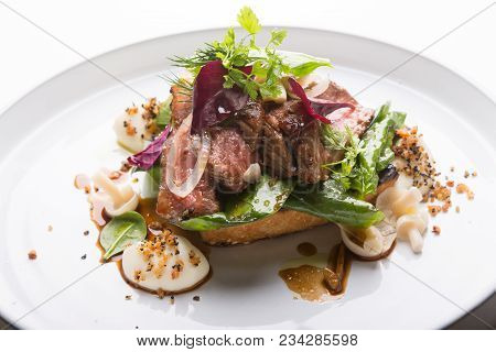 Prepared Roastbeef Served With Vegetables And Herbs On A Bread