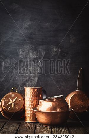 Different Kind Of Vintage Copper Cookware Over Dark Background