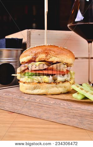 Top View Fresh Homemade Burger With Chicken, Salad, Cheese, Onion, Cucumber, Tomato, Sause And Dark 