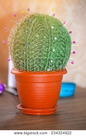 Cactus As A Handmade Needle Bed On A Brown Background