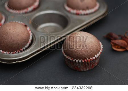 Just Baked Homebaked Chocolate Muffins For Dessert With Colored Conffeti. Black Background.