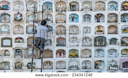 Ica, Peru - August 2017: A Keeper Is Taking Care Of The Above The Ground Tombs In The Ica Cemetery I