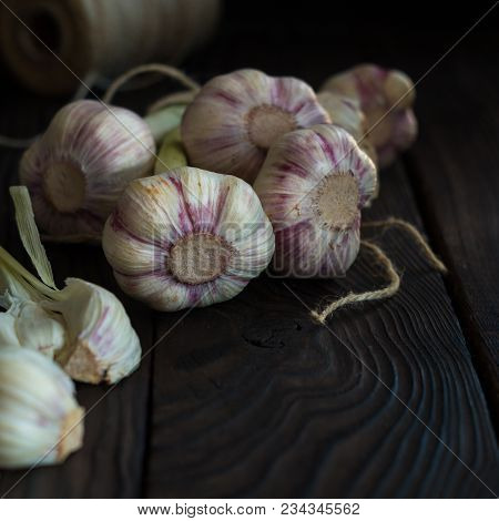 Garlic Heads On A Dark Wooden Table