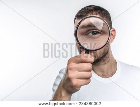 Man With Loupe Is Looking Straight Ahead And Showing His Eye Through The Glass. He Is An Investigato