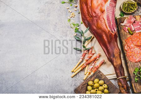 Appetizers Table With Spanish Iberian Whole Ham Jamon Serrano, Snacks, Olives And Red And Rose Wine.