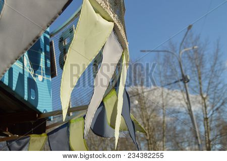 Close-up, Selective Focus, Wind Slaps Garlands Of Colorful Flags Against Blue Sky, Park In Spring.